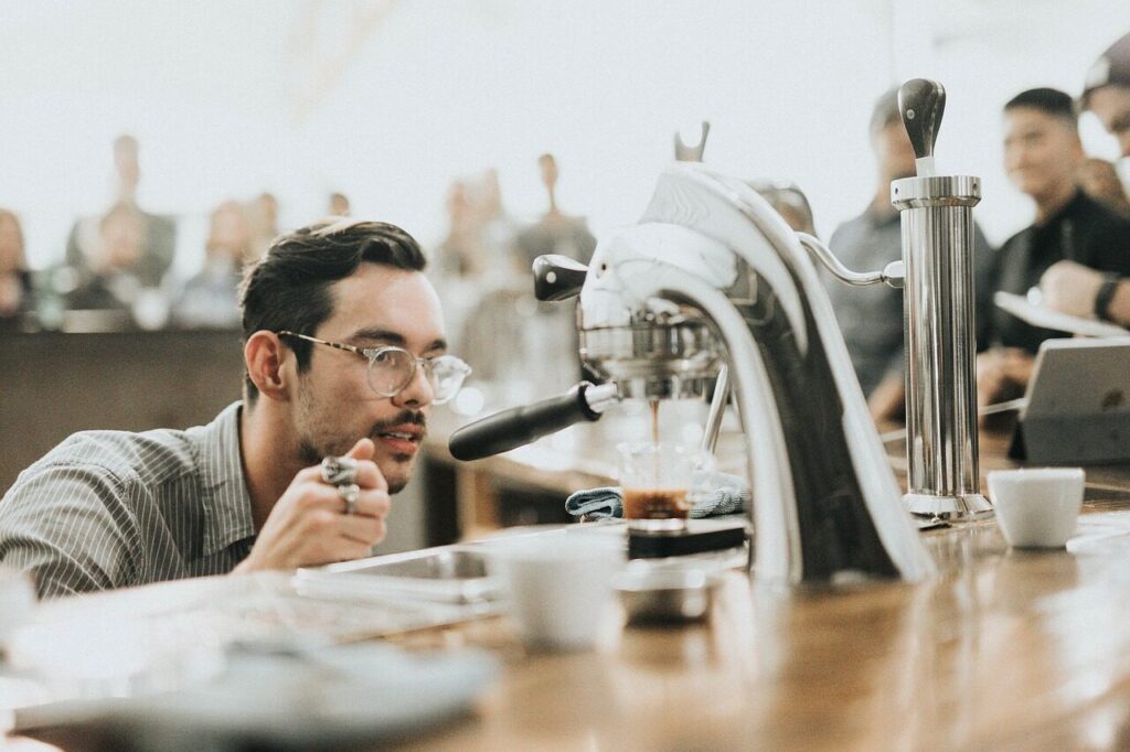 Espresso flowing from a portafilter into a small glass placed on a scale