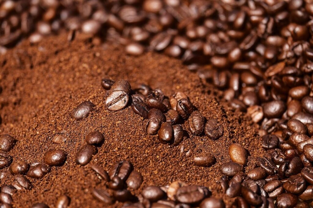 Ground coffee in a glass beaker sitting on a small kitchen scale