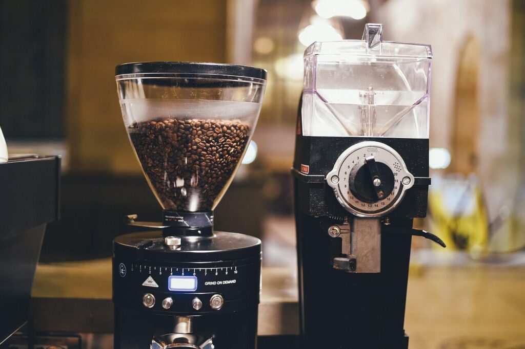 Hand adjusting the grind setting on an electric coffee grinder
