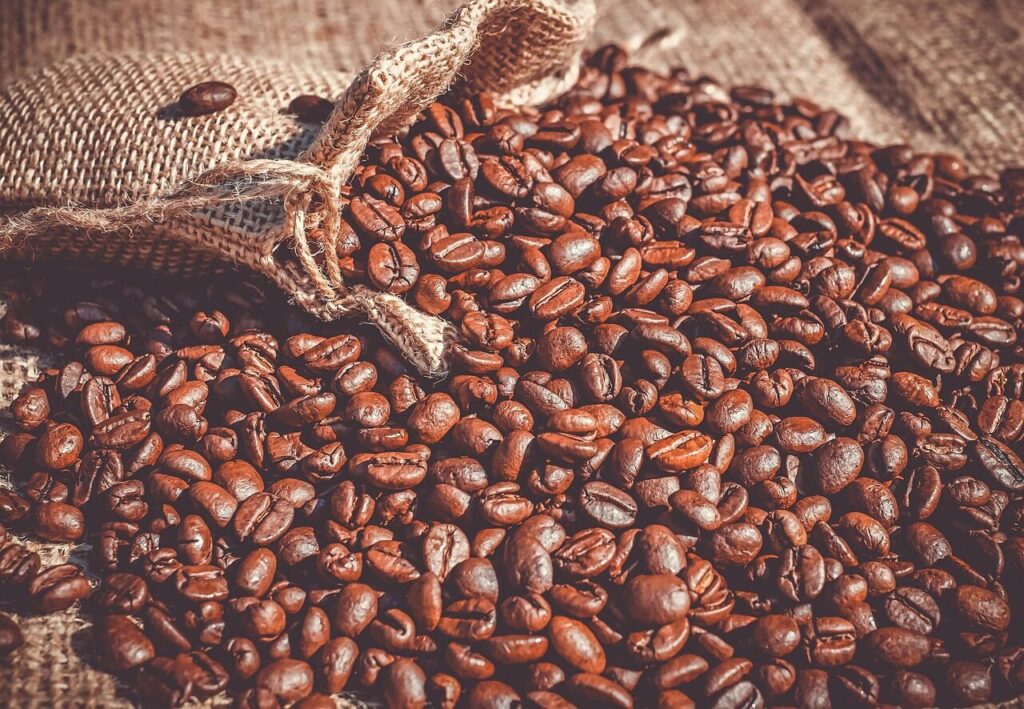 Resealable bag of freshly roasted coffee beans standing on a wooden table