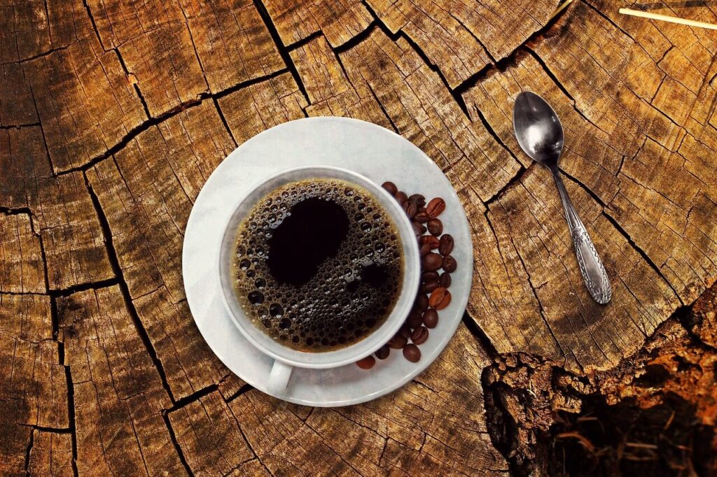Several small cups of brewed coffee lined up on a table for tasting