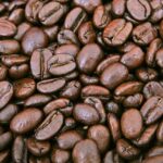 Three piles of coffee beans showing coffee roast levels from light to dark