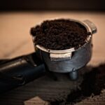 Weighing ground coffee on a digital scale to set the coffee to water ratio